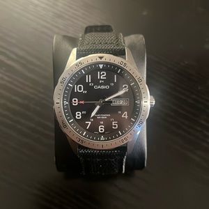 Casio watch. Solar powered. Stainless steel. Water resistant. Cloth strap.